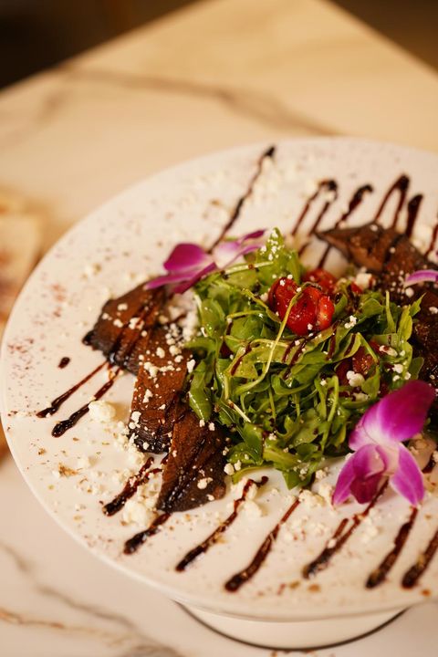 Arugula salad with sliced portobello mushrooms, crumbled goat cheese, grape tomatoes and balsamic glaze